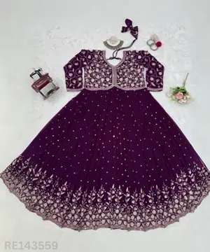 Woman wearing a Fox Georgette embroidered outfit at a festive event.